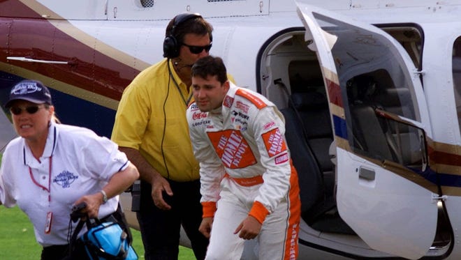 Tony Stewart arrives at 
Lowe's Motor Speedway via helicopter for the 1999 Coca-Cola 600 after running the Indianapolis 500. Stewart  became the first driver to complete both races in one day, finishing ninth at Indy and fourth in the Coca-Cola.