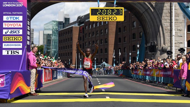 Geoffrey Kipkorir Kirui of Kenya celebrates winning the men's marathon.