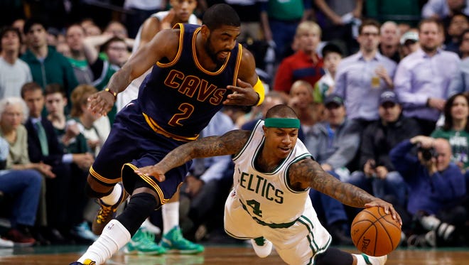 Boston Celtics guard Isaiah Thomas (4) works for the ball against Cleveland Cavaliers guard Kyrie Irving (2) during the second quarter in game three of the first round of the NBA Playoffs at TD Garden.