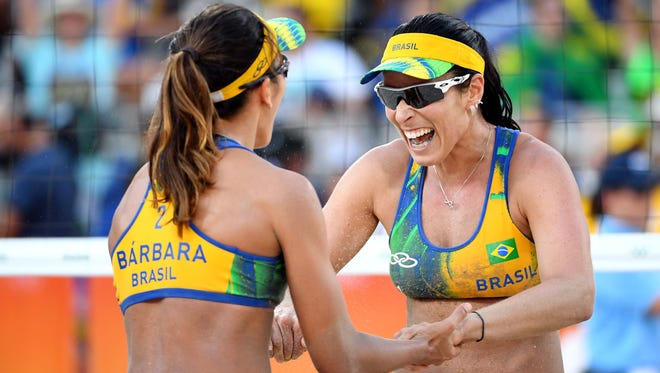 B. Rippel Agatha (BRA) celebrates with Barbara Seixas de Freitas (BRA) in their match agains the Czech Republic during the women's beach volleyball preliminary round in the Rio 2016 Summer Olympic Games at Beach Volleyball Arena. Mandatory Credit: