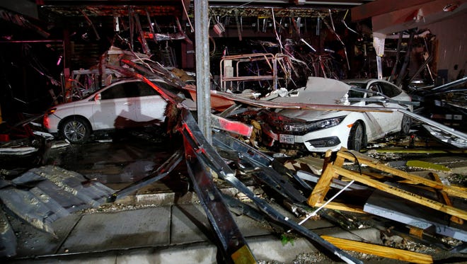 Cars and trucks are damaged as the walls blew out of the I-20 Dodge dealership after a tornado hit near Canton, Texas on April 29, 2017. The National Weather Service says at least one tornado hit Canton, while tornadoes also were reported in surrounding areas. Powerful storms swept through Canton early Saturday evening, leaving behind a trail of overturned vehicles, mangled trees and damaged homes.