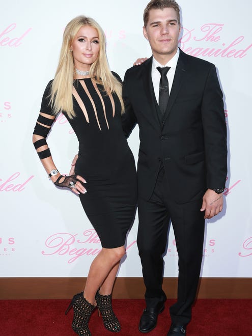 The pair looked smart in all black. Hilton pairing her cut-out dress with cut-out heels and lacey gloves.