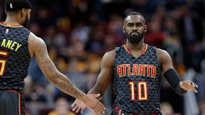 Atlanta Hawks' Tim Hardaway Jr., right, is congratulated by Malcolm Delaney after shooting a three-point basket in the second half of an NBA basketball game against the Cleveland Cavaliers, Friday, April 7, 2017, in Cleveland. (AP Photo/Tony Dejak)
