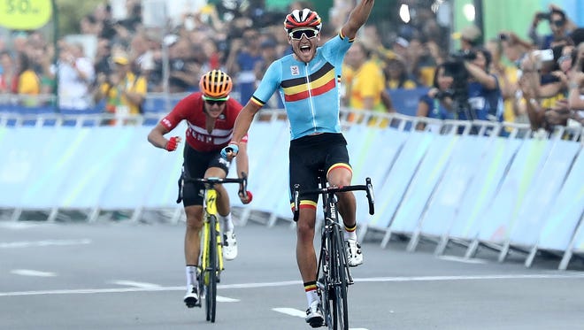 Greg van Avermaet of Belgium celebrates winning the gold medal ahead of Jakob Fuglsang of Denmark in the men's road race at the Rio 2016 Olympic Games at the Fort Copacabana.