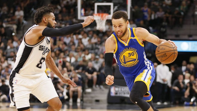Stephen Curry dribbles the ball as Patty Mills defends during the second half in Game 4 of the Western Conference finals.