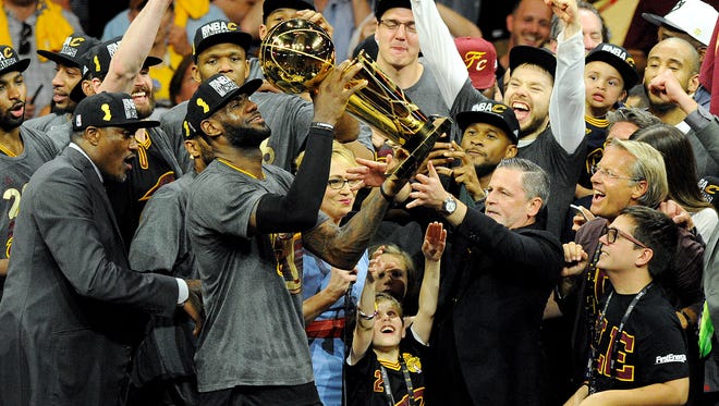 Cleveland Cavaliers forward LeBron James (23) celebrated with the Larry O'Brien Championship Trophy after beating the Golden State Warriors in game seven of the NBA Finals at Oracle Arena.
