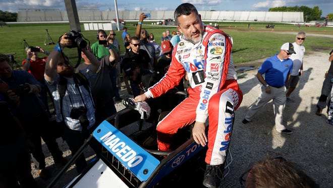 Tony Stewart climbs into Carson Macedo's midget race car to do a couple laps on the temporary 3/16th dirt oval made for him inside Turn 3 at Indianapolis Motor Speedway as part of his retirement celebration.