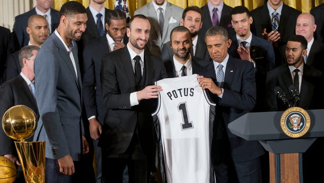 2014: President Barack Obama accepts a San Antonio Spurs team jersey from Tim Duncan, Ginobili and Tony Parker.