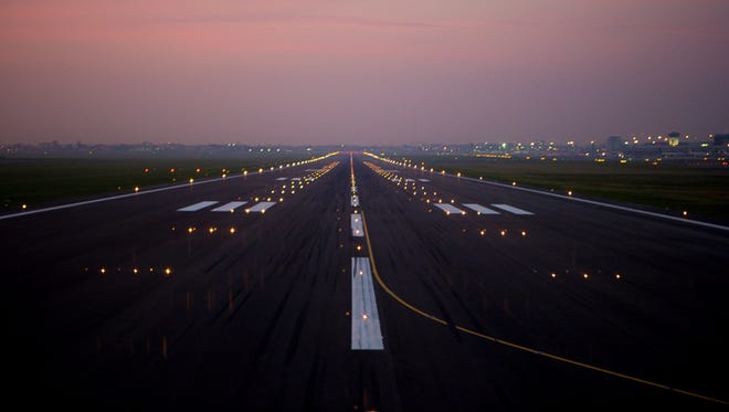 Day turns to dusk in brilliant colors over a runway in Warsaw's main airport.