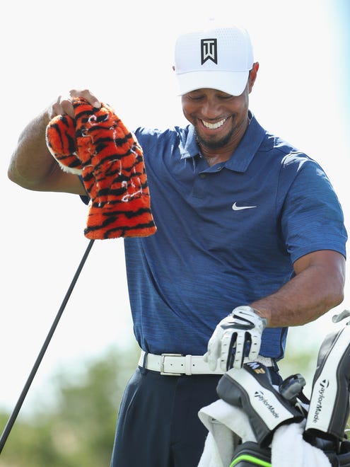 Tiger Woods smiles on the practice range before Round 2 of the Hero World Challenge.