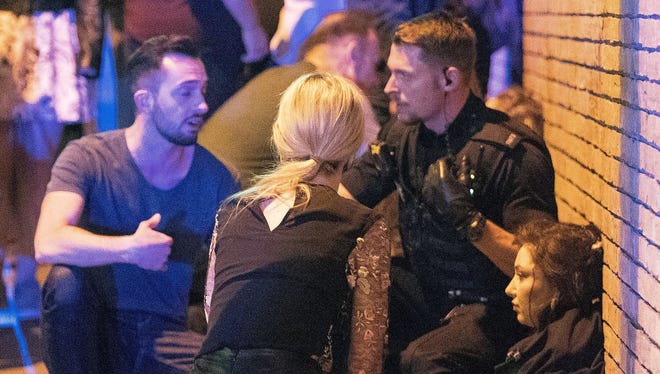 Police and other emergency services are seen near the Manchester Arena after reports of an explosion.