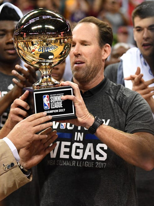 Los Angeles Lakers Summer League head coach Jud Buechler is handed the championship trophy.
