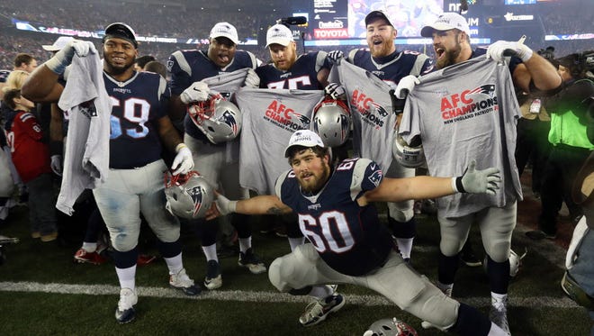 The New England Patriots celebrate after beating the Steelers.