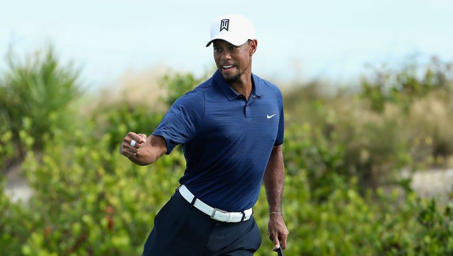 Tiger Woods celebrates one of his seven birdies during the second round.