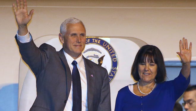 U.S. Vice President Mike Pence, left, and his wife Karen wave as they arrive in Sydney, Friday, April 21, 2017.