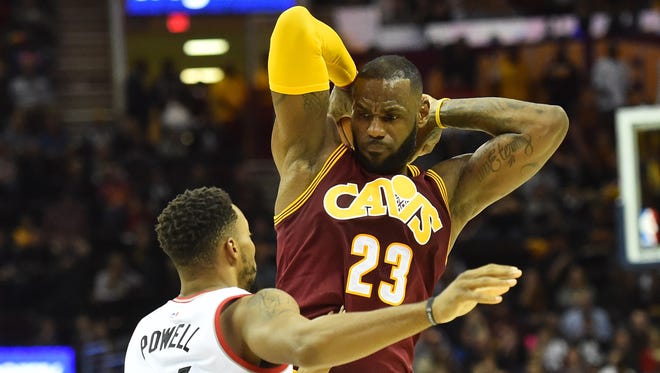 Cleveland Cavaliers forward LeBron James (23) holds the ball from Toronto Raptors guard Norman Powell (24) during the second quarter at Quicken Loans Arena.