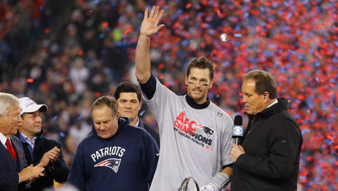Patriots quarterback Tom Brady (12) celebrates with the Lamar Hunt Trophy after defeating the Steelers.