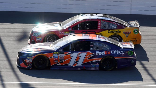 Denny Hamlin (11) and eventual winner Kyle Larson (42) race side-by-side during the FireKeepers Casino 400 at Michigan International Speedway on June 18.