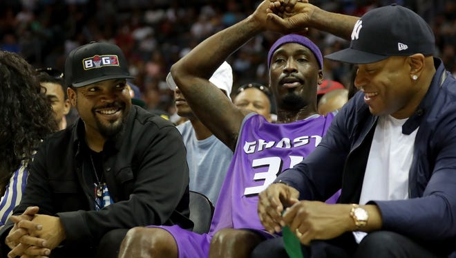 Ricky Davis #31 of the Ghost Ballers takes a seat between Ice Cube and LL Cool J during week two of the BIG3 three on three basketball league at Spectrum Center on July 2, 2017 in Charlotte, North Carolina.