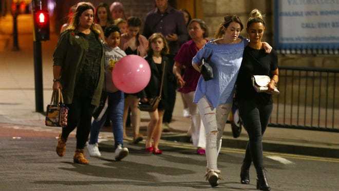 Members of the public are escorted from the Manchester Arena in Manchester, England.