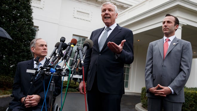 Charter Communications CEO Thomas Rutledge, center, Gov. Greg Abbott, R-Texas, left, and Reed Cordish, assistant to the president for intragovernmental and technology Initiatives, talk to reporters outside the White House in Washington on March 24, 2017, after a meeting with President Trump.