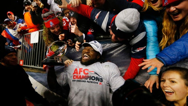 Patriots running back LeGarrette Blount celebrates with fans in the stands after defeating the Steelers.