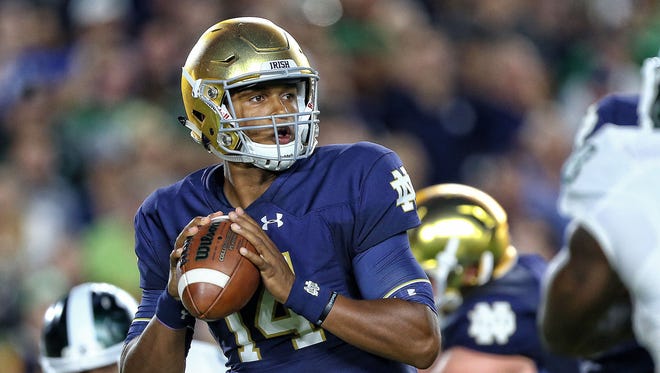 Notre Dame Fighting Irish quarterback DeShone Kizer (14) attempts to throw the ball against the Michigan State Spartans during the first quarter of a game at Notre Dame Stadium.