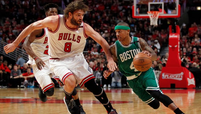 Boston Celtics guard Isaiah Thomas (4) moves around Chicago Bulls center Robin Lopez (8) during the second half in Game 3 of the first round of the 2017 NBA Playoffs.