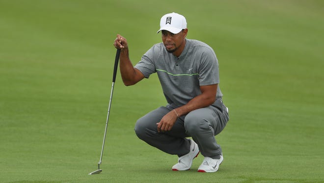 Tiger Woods lines up his putt on the first green during Round 3 of the Hero World Challenge.