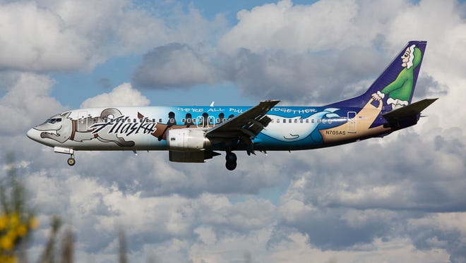 Alaska Airlines' "Spirit of Alaska Statehood" Boeing 737-400 lands in Seattle. The jet's unique design was created by a high school student from Sitka, Alaska, in 2009.