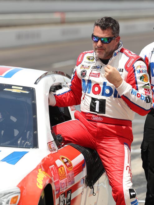 Tony Stewart climbs out of his car after qualifying for the Combat Wounded Coalition 400 at Indianapolis Motor Speedway on July 23. Stewart will start third in his final Brickyard race.