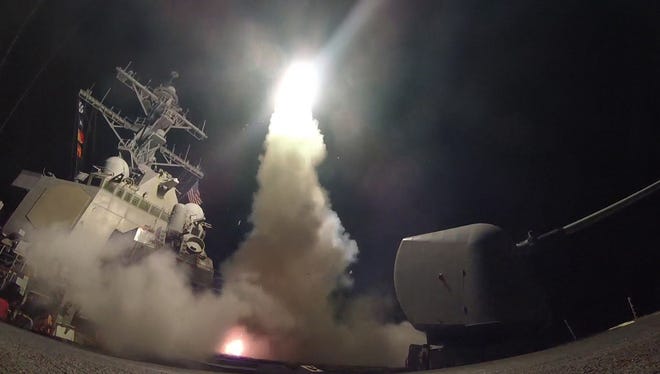 A handout photo made available by the US Navy Office of Information shows the guided-missile destroyer USS Porter launching a missile strike while in the Mediterranean Sea on Friday. The United States military launched at least 50 tomahawk cruise missiles against al-Shayrat military airfield near Homs, Syria, in response to the Syrian military's alleged use of chemical weapons in an airstrike in a rebel held area in Idlib province on Tuesday.