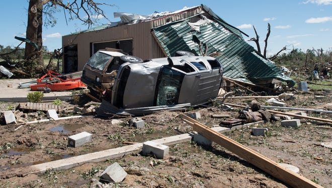 An overturned vehicle rests on the ground surrounded by debris in Canton, Texas, on April 30, 2017, after tornadoes hit the area.