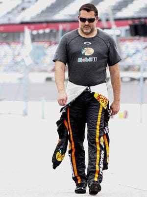 Three-time Sprint Cup champion Tony Stewart walks through the pits before practice for the Coke Zero 400 last month at Daytona International Speedway.