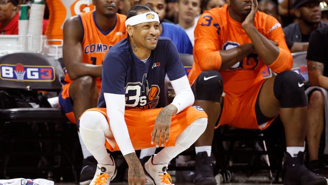 3's Company player/captain and coach Allen Iverson, center, kneels on the sideline.
