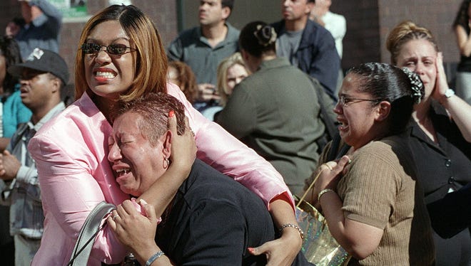 Two women hold each other as they watch the World Trade Center burn.