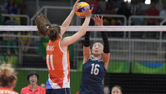 Anne Buijs (11) of the Netherlands defends Xia Ding of China during their match in the Rio 2016 Summer Olympic Games at Maracanazinho.