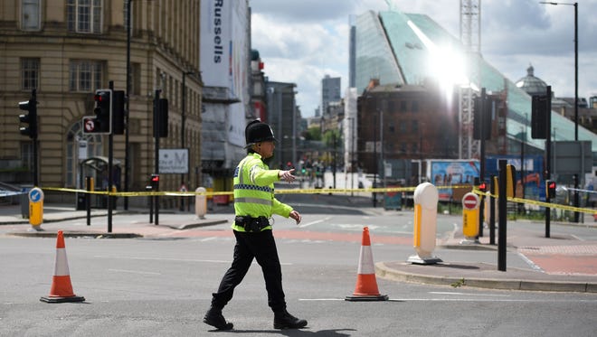 A police officer patrols a cordon near the Manchester Arena in Manchester, England, on May 23, 2017.