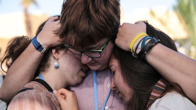 Environmental activists comfort each other during a protest against President-elect Donald Trump at the Climate Conference, known as COP22, in Marrakech, Morocco, Nov. 9, 2016.