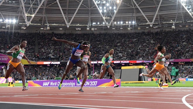 Tori Bowie of the USA leans at the line to defeat Marie-Josee Ta Lou of Ivory Coast in the 100 final.