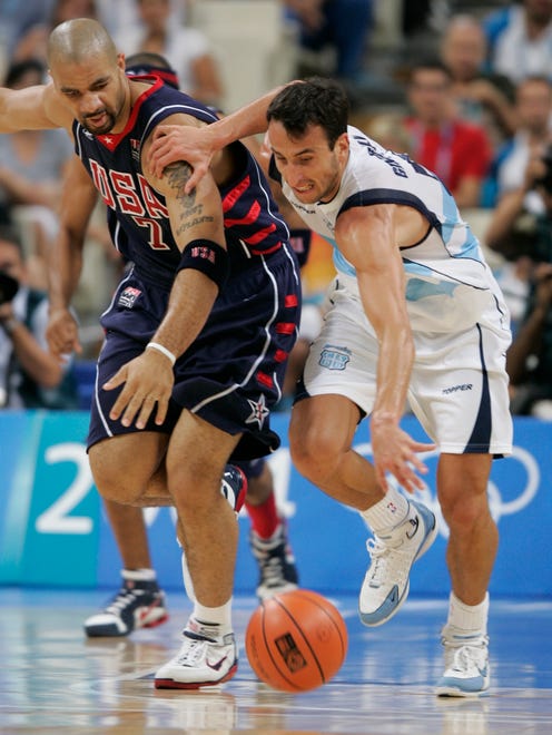 2004: Carlos Boozer battles for a loose ball with Ginobili as the USA men's basketball team was defeated by Argentina.