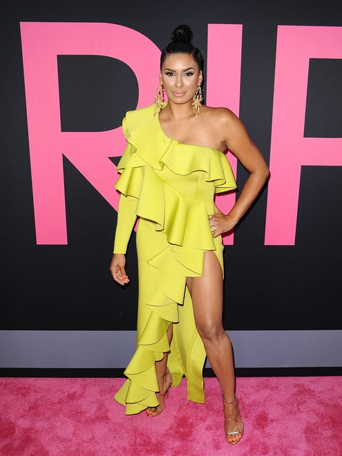 Laura Govan lit up the pink carpet in a bright yellow, asymmetrical dress and large earrings.