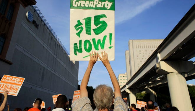 Protestors march in support of raising the minimum wage to $15 an hour as part of an expanding national movement known as Fight for 15, on Wednesday, April 15, 2015, in Miami.