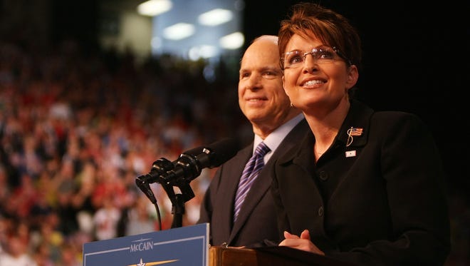 McCain stands with Palin at a campaign rally on Aug. 29, 2008, in Dayton, Ohio, after she was announced as his running mate.