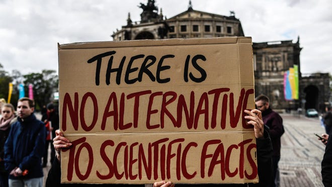 A protester holds a sign during the March for Science in Dresden, Germany.