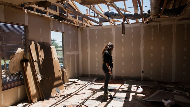 Stephanie Quezada looks at the damage to the second floor of her father's church, Primera Iglesia Bautista, in Canton, Texas onApril 30, 2017. Severe storms including tornadoes swept through several small towns in East Texas, killing several and leaving a trail of overturned vehicles, mangled trees and damaged homes, authorities said Sunday.