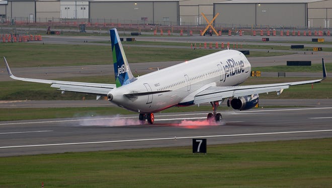 A JetBlue Airbus A321 greases the runway at Paine Field Airport, otherwise known as the home of Boeing's wide-body jet factory.