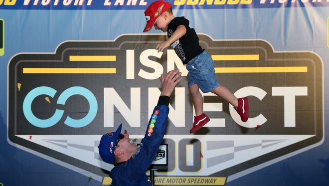 Kyle Busch tosses his son Brexton into the air in victory lane after winning the playoff race at New Hampshire Motor Speedway on Sept. 24.