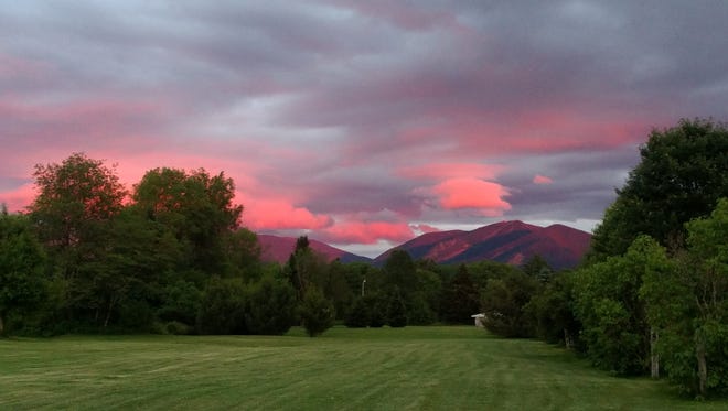 A view of the sun set over Cannon Mountain and the Kinsman Ridge from the Gale River Motel in Franconia, New Hampshire.