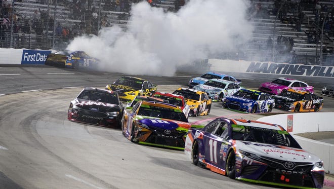 Chase Elliott (top left) crashes into the wall after being spun by Denny Hamlin (11) in the closing laps at Martinsville Speedway on Oct. 29. Hamlin would later get passed by eventual winner Kyle Busch (behind Hamlin) on the overtime restart.